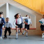 students running together inside the school