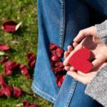 person holding heart shaped cut out