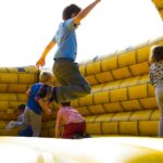 children playing on inflatable castle