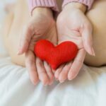 crop woman with heart on palms