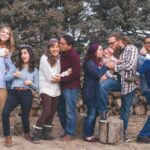 people standing in front of wood pile