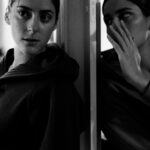 woman in black hoodie in grayscale photography